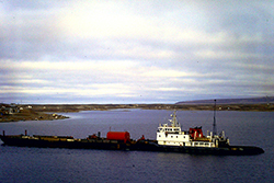 NTCL tug and barge in Cambridge Bay mid 1980’s. Photograph Courtesy of Captain Todd Gilmore